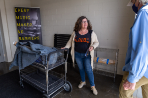 author Dina Pearlman standing in the foyer of The Record Co with ARP synth